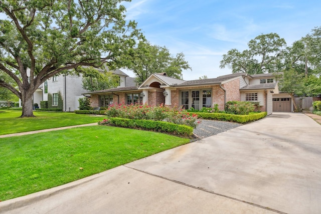 ranch-style house featuring a garage, concrete driveway, a front lawn, and brick siding