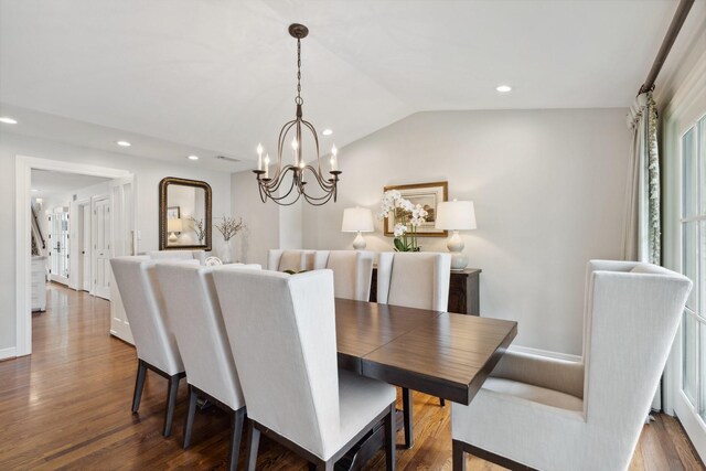 dining space with lofted ceiling, baseboards, recessed lighting, dark wood-type flooring, and a chandelier