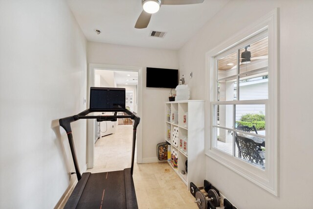 workout area featuring baseboards, ceiling fan, and visible vents