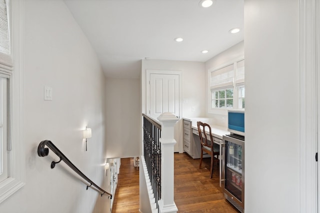 interior space with wine cooler, recessed lighting, and wood finished floors