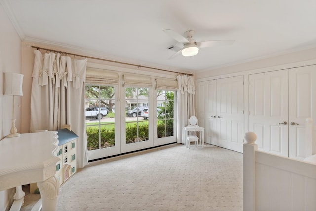 unfurnished room featuring ornamental molding, carpet, and ceiling fan