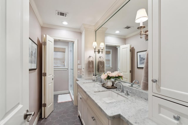 full bathroom featuring crown molding, visible vents, and a sink