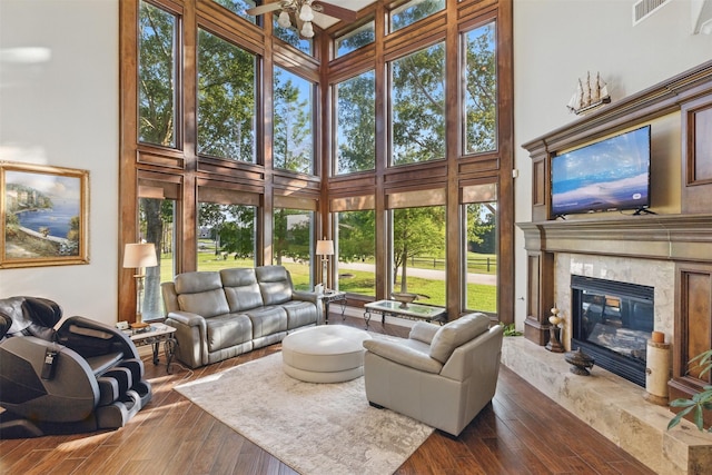 90 Greenview St, Montgomery, TX 77356 - living room featuring a towering ceiling, ceiling fan, wood finished floors, and a fireplace