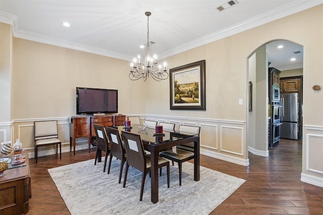90 Greenview St, Montgomery, TX 77356 - dining room featuring arched walkways, crown molding, a chandelier, dark wood-style floors, and a decorative wall