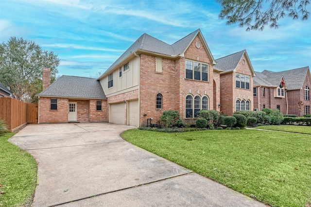 view of front of property with concrete driveway, a front lawn, an attached garage, and fence