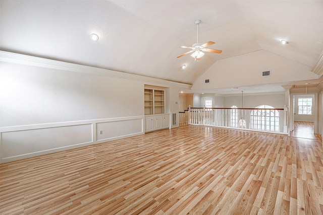 interior space featuring built in shelves, a ceiling fan, visible vents, light wood-style flooring, and vaulted ceiling