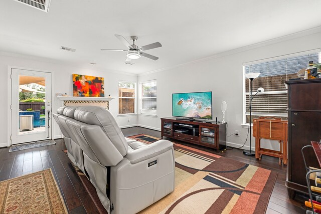 living area featuring a ceiling fan, visible vents, a wealth of natural light, and hardwood / wood-style floors