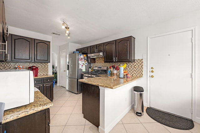 kitchen with under cabinet range hood, stainless steel appliances, light tile patterned flooring, and visible vents