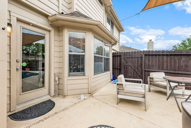 view of patio / terrace featuring fence and a gate