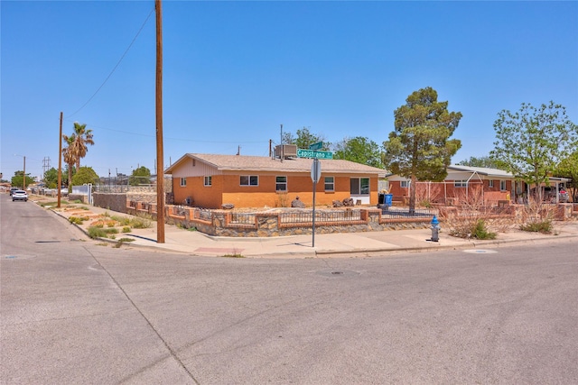 ranch-style home with fence