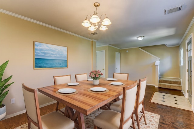 dining space with visible vents, wood finished floors, crown molding, and stairway