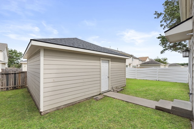 view of outdoor structure featuring an outbuilding and a fenced backyard