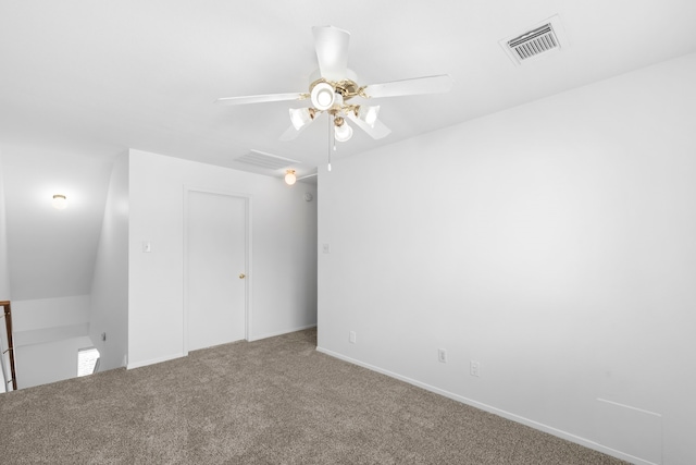 carpeted empty room featuring visible vents, a ceiling fan, and baseboards