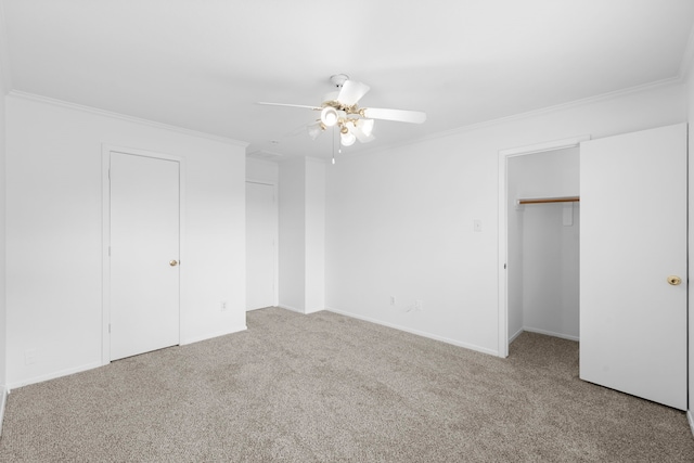 unfurnished bedroom with ornamental molding, a closet, and carpet flooring