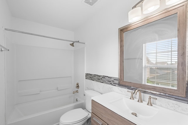bathroom with  shower combination, tile walls, toilet, vanity, and visible vents