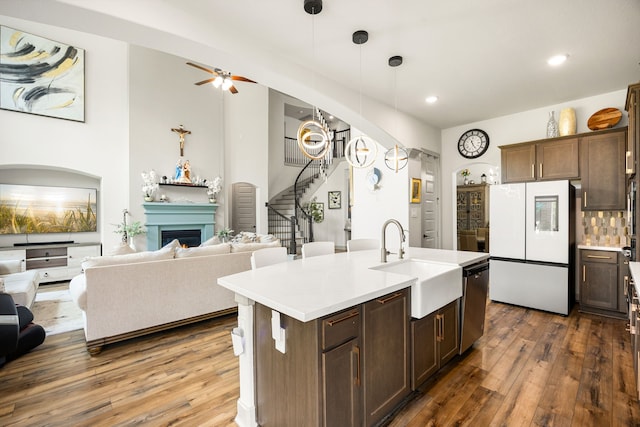 kitchen with freestanding refrigerator, open floor plan, and a sink