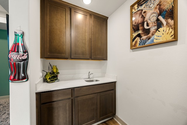 bar with baseboards and a sink