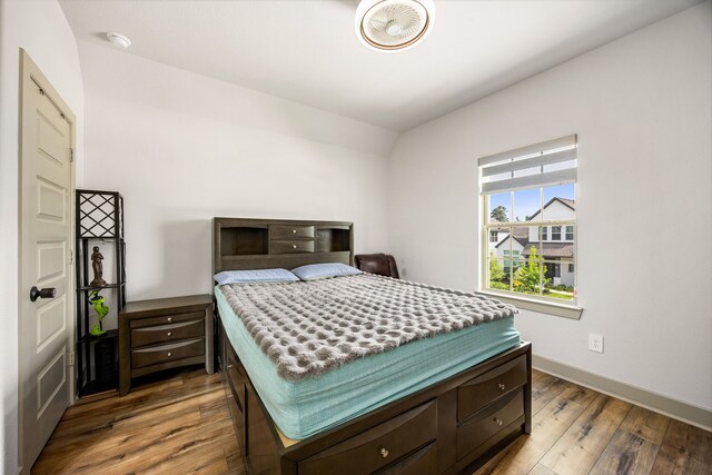 bedroom featuring wood-type flooring and baseboards