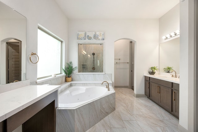 bathroom featuring a walk in shower, vanity, marble finish floor, a bath, and a closet