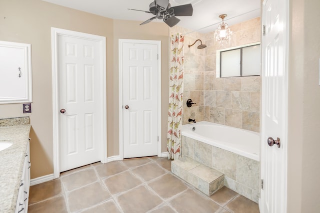 bathroom featuring vanity, tiled shower / bath, ceiling fan, baseboards, and tile patterned flooring