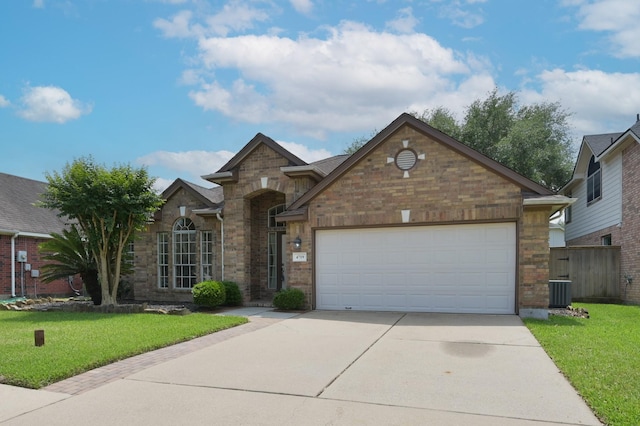 4719 Meadows Edge Ln, Houston, TX 77084 - view of front facade featuring concrete driveway, a front lawn, an attached garage, and brick siding