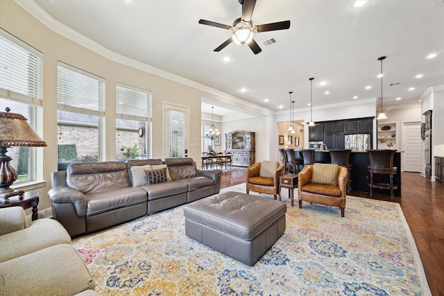 19907 Cullen Ridge Dr, Porter, TX 77365 - living room featuring visible vents, ornamental molding, ceiling fan with notable chandelier, and dark wood-type flooring