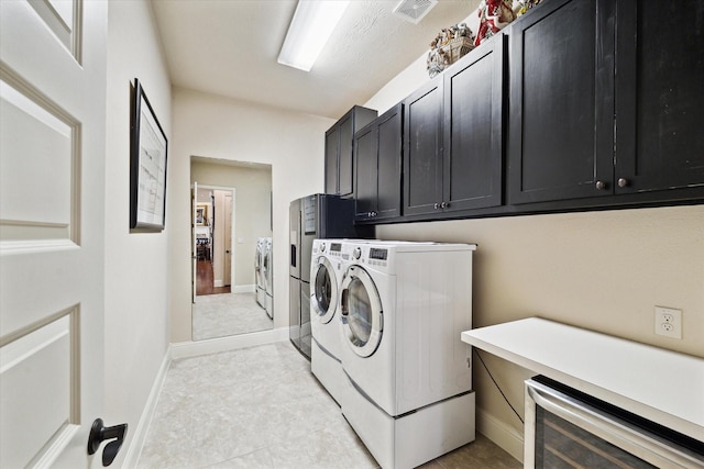 19907 Cullen Ridge Dr, Porter, TX 77365 - laundry room with cabinet space, baseboards, visible vents, washer and clothes dryer, and wine cooler