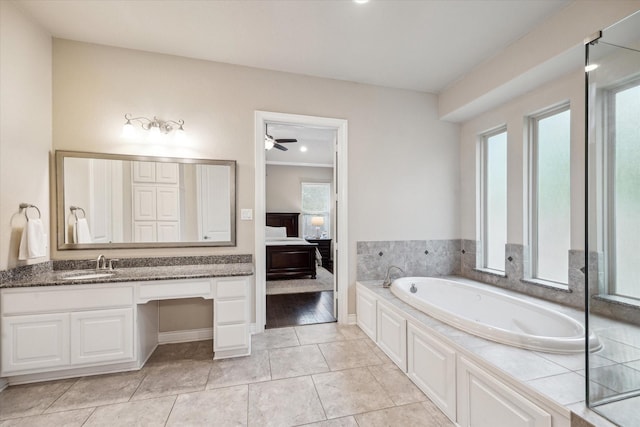 bathroom with crown molding, ensuite bathroom, a garden tub, vanity, and a ceiling fan