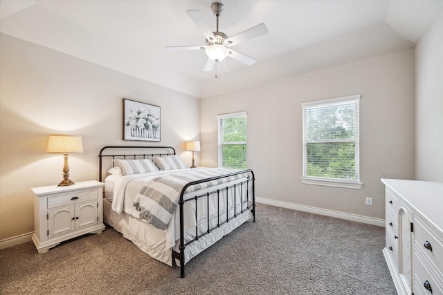 bedroom featuring dark colored carpet, a ceiling fan, and baseboards