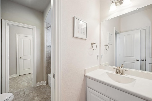 bathroom with toilet, shower / bathtub combination, vanity, and baseboards