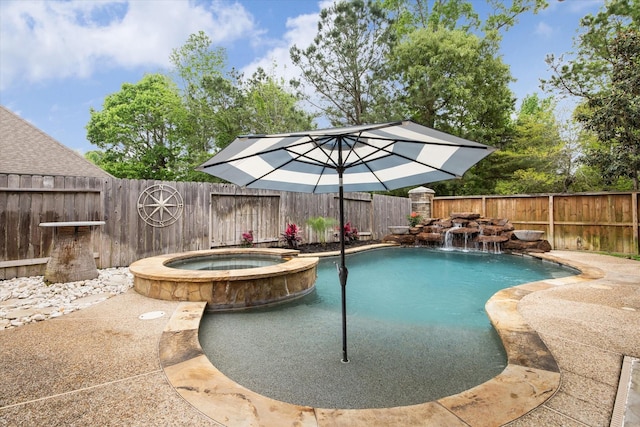 view of swimming pool featuring a fenced backyard and a pool with connected hot tub
