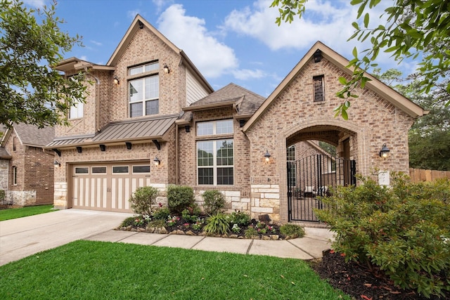 view of front facade featuring driveway, a front yard, an attached garage, fence, and brick siding