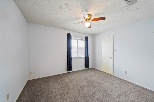 carpeted empty room with a textured ceiling, ceiling fan, visible vents, and baseboards