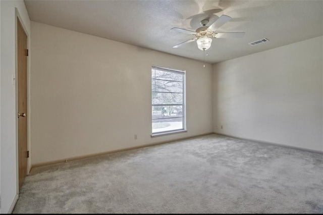 215 N Howard St, Tomball, TX 77375 - spare room featuring carpet floors, ceiling fan, and baseboards