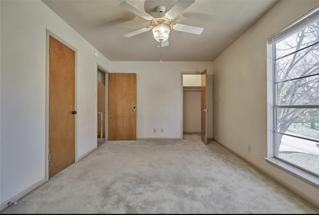215 N Howard St, Tomball, TX 77375 - unfurnished bedroom with carpet floors, multiple windows, and a ceiling fan