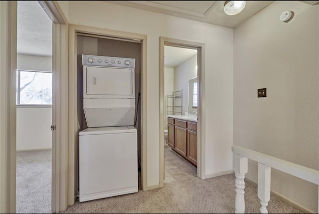 215 N Howard St, Tomball, TX 77375 - washroom with estacked washer and dryer and light colored carpet
