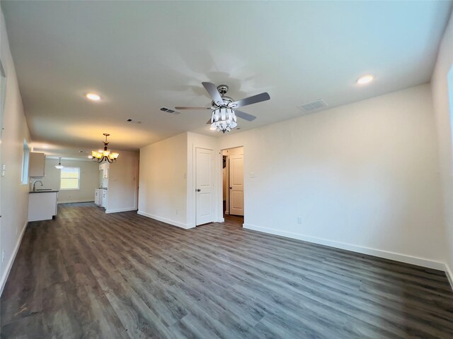 5618 Grace Point Ln, Houston, TX 77048 - unfurnished living room with ceiling fan with notable chandelier, visible vents, dark wood-style flooring, and baseboards