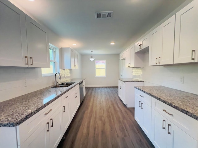 5618 Grace Point Ln, Houston, TX 77048 - kitchen with tasteful backsplash, stainless steel dishwasher, a sink, baseboards, and dark wood finished floors