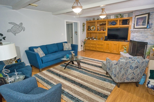 living room featuring beam ceiling and light wood-style floors