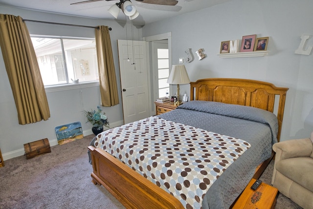 carpeted bedroom with ceiling fan and baseboards