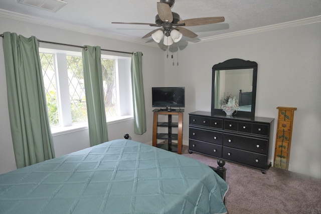 bedroom with visible vents, ceiling fan, carpet floors, and crown molding