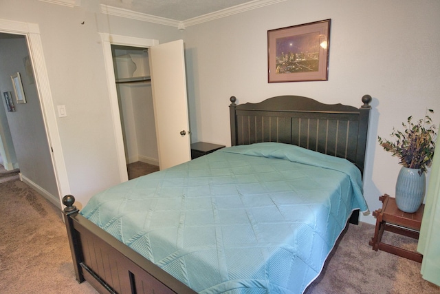 carpeted bedroom with baseboards, a closet, and crown molding
