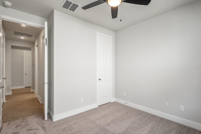 17311 Sunflower Petals Trl, Conroe, TX 77302 - unfurnished bedroom with baseboards, visible vents, and carpet