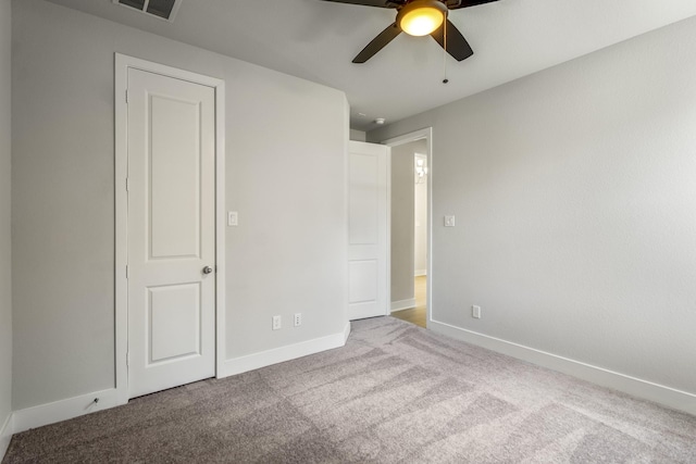 17311 Sunflower Petals Trl, Conroe, TX 77302 - unfurnished bedroom featuring baseboards, visible vents, ceiling fan, and carpet flooring
