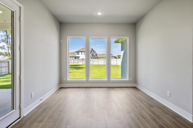 17311 Sunflower Petals Trl, Conroe, TX 77302 - empty room featuring wood finished floors, recessed lighting, and baseboards