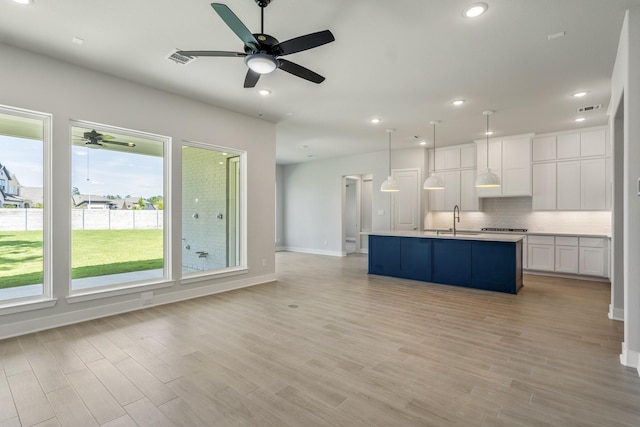 17311 Sunflower Petals Trl, Conroe, TX 77302 - unfurnished living room with a sink, recessed lighting, ceiling fan, and light wood-type flooring