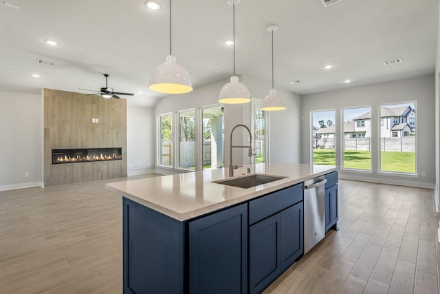 17311 Sunflower Petals Trl, Conroe, TX 77302 - kitchen featuring open floor plan, stainless steel dishwasher, light wood finished floors, and a sink