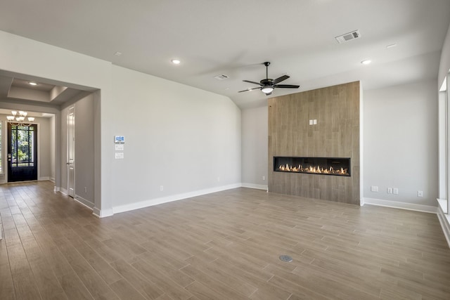 17311 Sunflower Petals Trl, Conroe, TX 77302 - unfurnished living room featuring wood finished floors, visible vents, a large fireplace, and baseboards