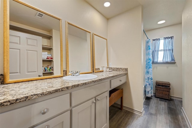 736 County Road 478, Lott, TX 76656 - full bathroom with a shower with curtain, visible vents, wood finished floors, vanity, and baseboards