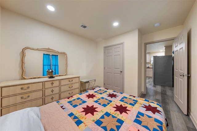 736 County Road 478, Lott, TX 76656 - bedroom with freestanding refrigerator, recessed lighting, visible vents, and dark wood-type flooring